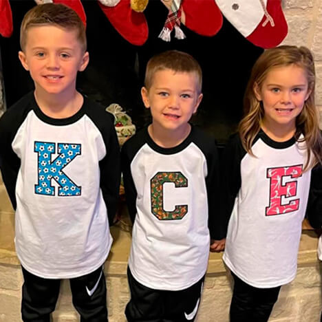 kids wearing varsity letter embroidered shirts